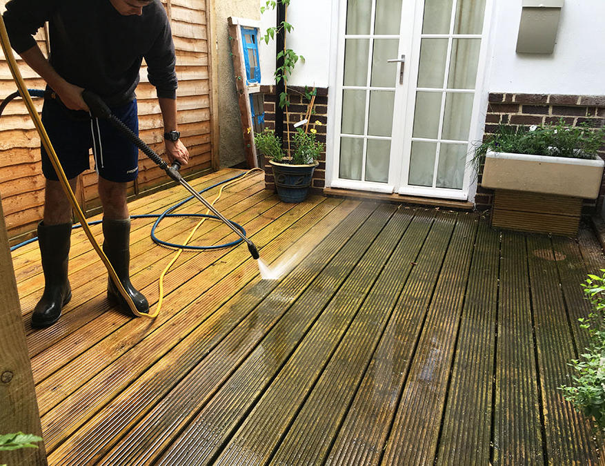 man cleaning floor with water