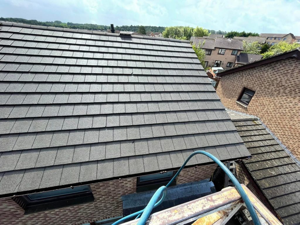 Technician at top of roof ready for cleaning roof in Glasgow